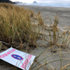 The oceanfront lot bought by Facebook for the site of its proposed landing spot for a submarine fiberoptic cable that would connect America with Asia is seen in Tierra del Mar, Oregon with an anti-Facebook sign.